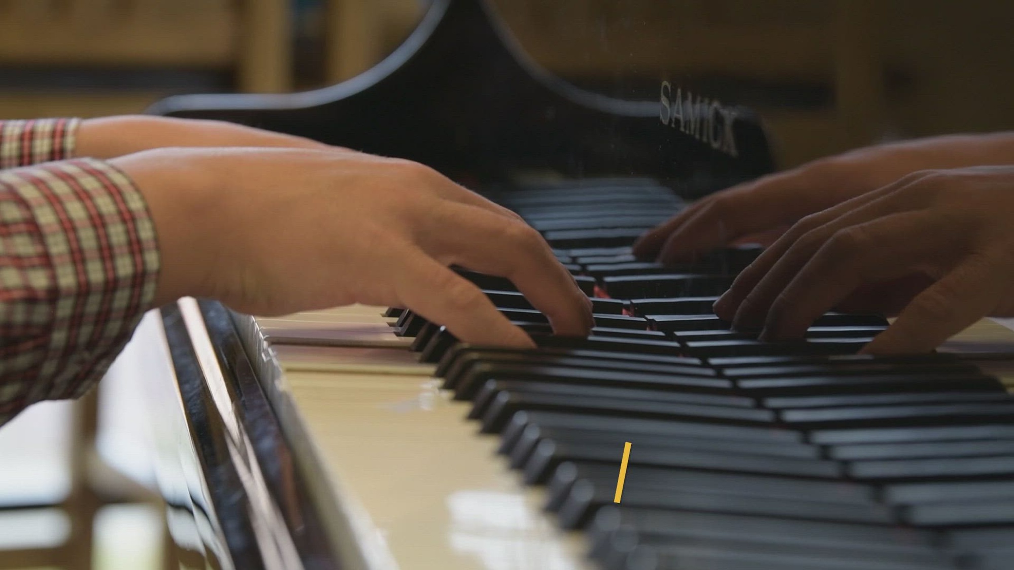 Nick Williams Jr. plays the piano during lunch time for the 2021 holiday season to give joy to military members away from their homes and families. (U.S. Air Force Video by Senior Airman James Kennedy)