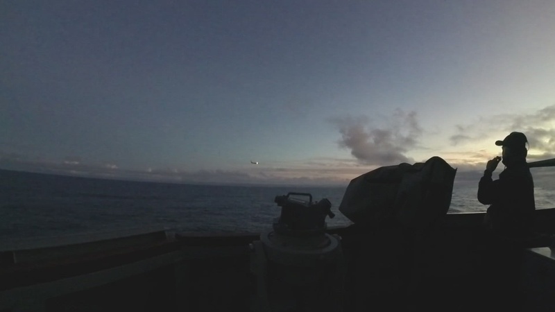 P8 Poseidon flies past USS Ross