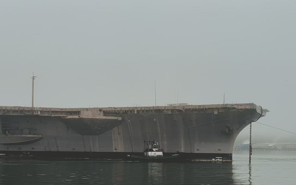 Ex-USS Kitty Hawk towed in its final transit from Naval Base Kitsap – Bremerton, Washington.