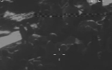 An Air Station Clearwater C-130 airplane crew spotted an overloaded Haitian sail freighter with 179 people aboard approximately 30 miles off Andros Island, Bahamas, Feb. 27, 2022. The people were transferred to Bahamian authorities. (U.S. Coast Guard video)