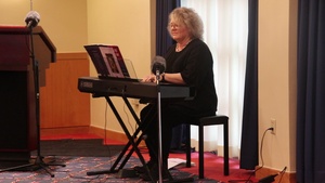 Pianist Michelle Jones plays during Fort McCoy's 2022 Memorial Day Prayer Luncheon