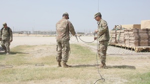 13th ESC commander aids Soldiers in tearing down equipment