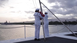 Abraham Lincoln Sailors lower the national ensign
