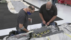 Inflation, inspection of the KC-46 aircraft door slide, raft