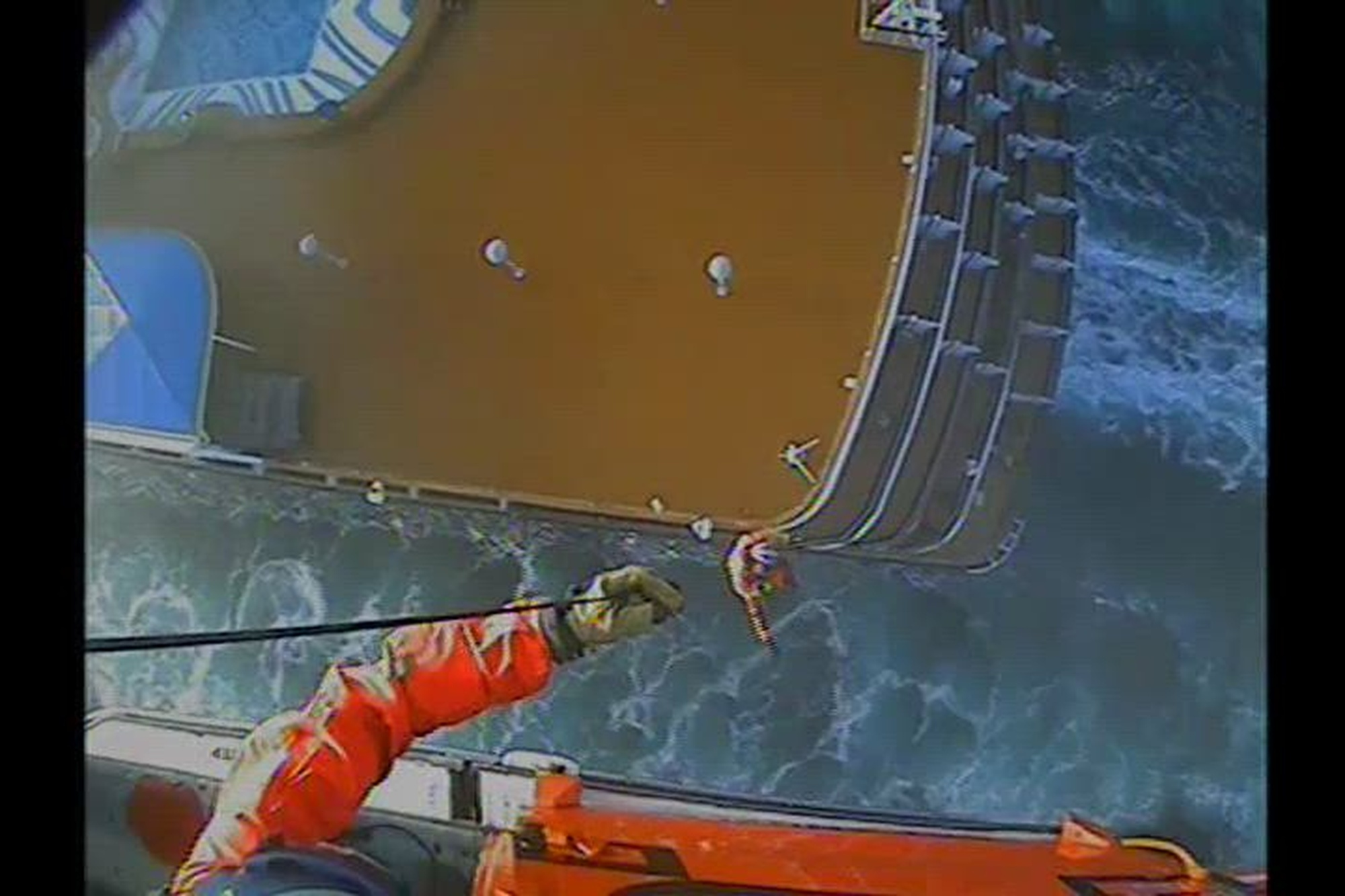 A U.S. Coast Guard MH-65 Dolphin helicopter crew from Coast Guard Station Port Angeles medically evacuates a woman from a cruise ship in Port Angeles, Washington, Oct. 3, 2022. The man was reported (U.S. Coast Guard courtesy video)