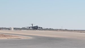 Airmen Unload Cargo Off A C-5M Super Galaxy