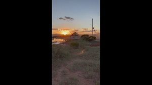Bradley Fighting Vehicles head out to training ranges at dusk