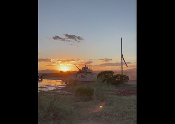 Bradley Fighting Vehicles head out to training ranges at dusk
