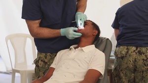 U.S. Navy Sailors assigned to the USNS Comfort perform dental care at a medical site in Azua, Dominican Republic during Continuing Promise 2022