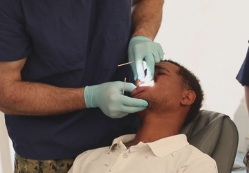 U.S. Navy Sailors assigned to the USNS Comfort perform dental care at a medical site in Azua, Dominican Republic during Continuing Promise 2022