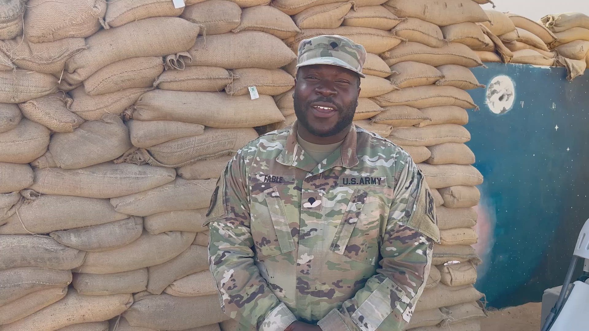U.S. Army Spc. Andrew Fable, a transportation management coordinator with the 528th Movement Control Team, Task Force Gator, from Miramar, Florida, gives a holiday season shout-out to his friends and family while forward deployed to Muwaffaq Salti Air Base (MSAB), Azraq, Jordan, Dec. 7, 2022. (U.S. Army National Guard video by Staff Sgt. Sebastian Rothwyn)