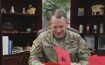 Gen. Todd R. Wasmund opens Christmas Cards from Primary Village North Elementary