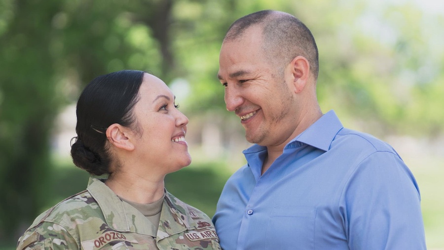 Photo of a woman in military uniform and a man in a blue shirt.