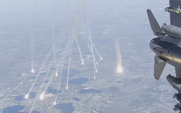 Two fighter jets depart and deploy flares