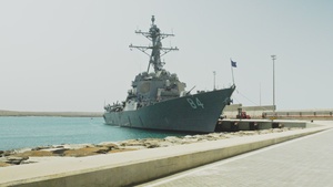Secretary of the Navy Carlos Del Toro walks ashore after visiting the crew of USS Bulkeley (DDG 84)