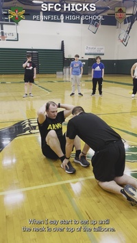 Sgt. 1st Class Hicks conducts PT with students