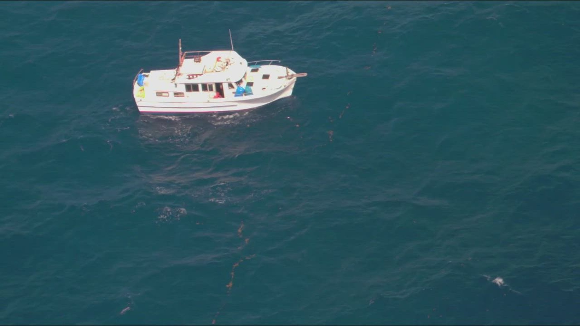 A Coast Guard Aviation Training Center Mobile HC-144 Ocean Sentry aircrew flies over a vessel taking on water while the Carnival Valor arrives on scene to rescue the three boaters aboard it 386 miles offshore Alabama in the Gulf of Mexico on March 26, 2023. The vessel taking on water, Snail Mail, had three boaters aboard that were transferred to the Carnival Valor&#39;s ship doctor. All three boaters were last reported to be in stable condition. (U.S. Coast Guard photo by Aviation Training Center Mobile)