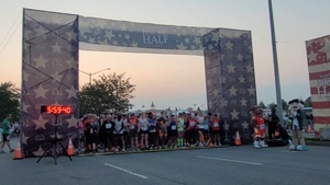 Runners cross the start line of the 2023 Marine Corps Marathon Historic Half