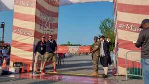 Footage of 2023 Devil Dog Double winner crossing finish line, post-race interview with sister, daughter