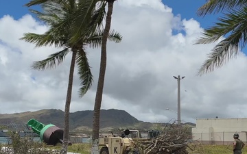 U.S. Marines clear trees from U.S. Coast Guard Forces Micronesia following Typhoon Mawar