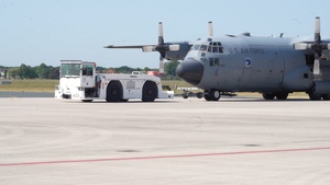 U.S. Airmen and German soldiers offload a C-17 Globemaster aircraft in preparation for exercise Air Defender 2023