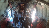 German paratroopers jump from a C-130J Super Hercules during Air Defender 2023