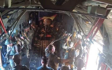 German paratroopers jump from a C-130J Super Hercules during Air Defender 2023