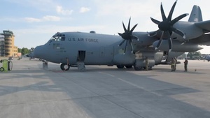A U.S. C-130 Hercules aircraft with the 153rd Airlift Wing air drops cargo at exercise Air Defender 2023