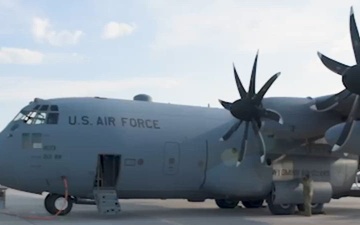 A U.S. C-130 Hercules aircraft with the 153rd Airlift Wing air drops cargo at exercise Air Defender 2023