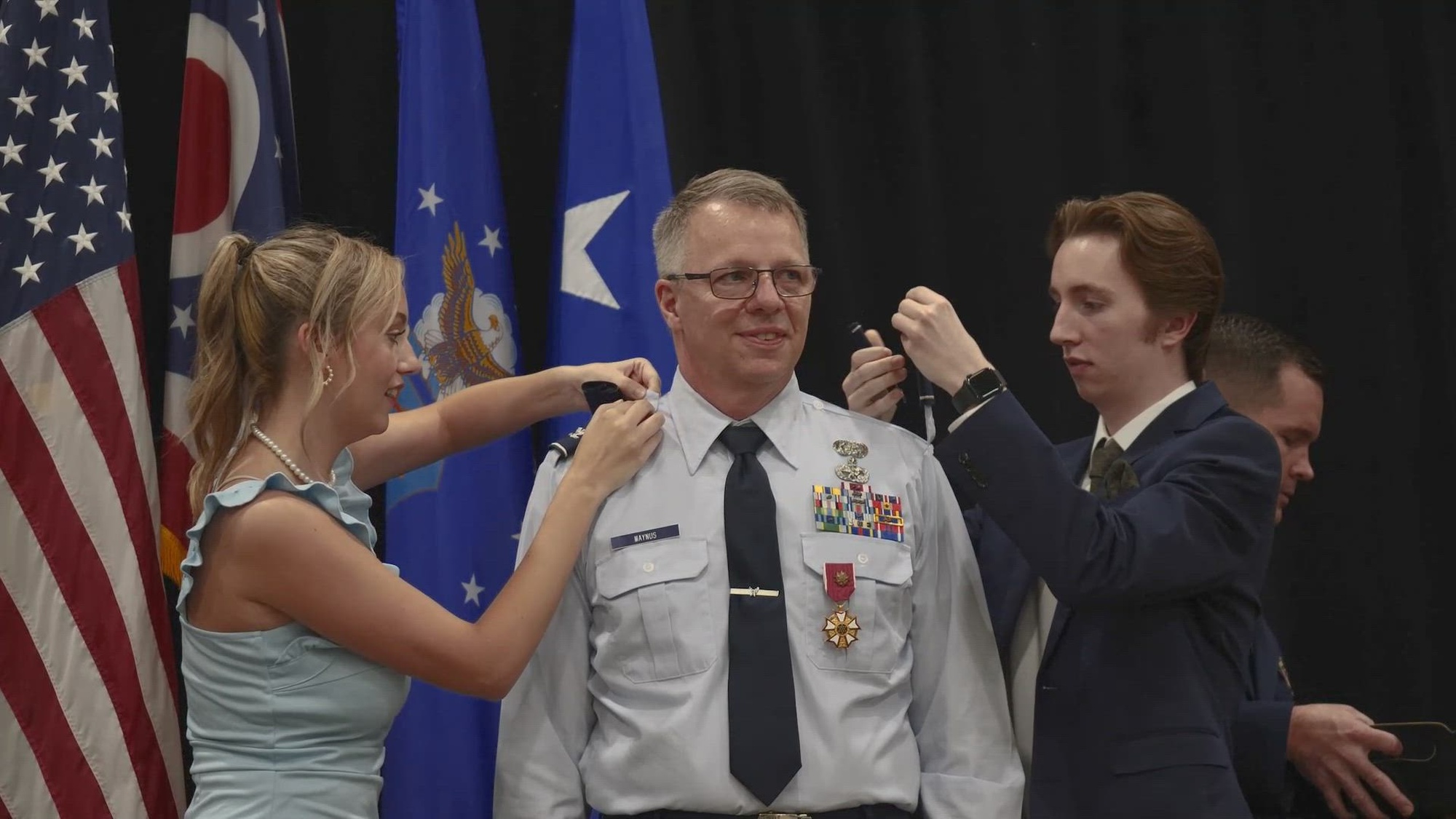 Col. Clarence K. Maynus, Ohio Air National Guard chief of staff, receives his promotion to brigadier general during a ceremony at the Maj. Gen. Robert S. Beightler Armory in Columbus, Ohio, June 22, 2023. In his position, Maynus leads and oversees a state headquarters that helps ensure the mission readiness of over 5,000 Ohio Air National Guard personnel who support a variety of community, state and federal missions. (U.S. Army National Guard video by Staff Sgt. Aven Santiago, Ohio National Guard Public Affairs)