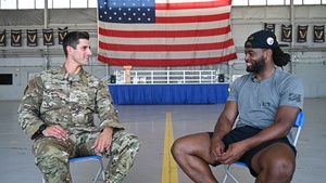 Najee Harris, Pittsburgh Steelers’ running back, interviews U.S. Air Force Senior Airman Matthew Garrett, a 23rd Special Tactics Squadron combat controller.