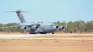 U.S. Airmen and RAAF Aviators unload Hawaiian Raptors Squadron equipment during TS23