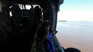 Multinational service members jump from UH-60
