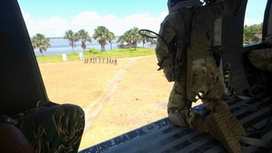 Multinational service members jump from UH-60