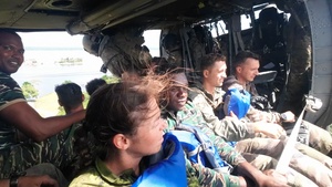 Multinational service members jump from UH-60