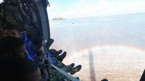 Multinational service members jump from UH-60