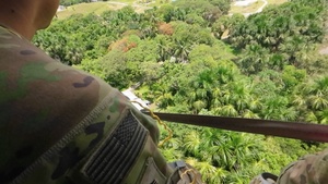 Multinational service members jump from UH-60