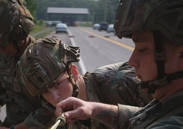 Soldiers from units within the XVIII Airborne Corps, rappel down a cliff face as part of the Best Squad Competition 2023