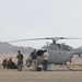 Marines and Sailors conduct a ground refuel on an MQ-8C Fire Scout.