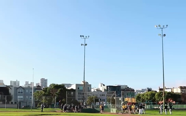 Service Members Compete with Local Teams in a Softball Tournament