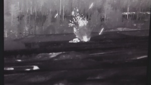 An Apache releases ammunition on a target during Gunnery Livefire