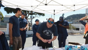 U.S. Coast Guardsmen distribute food to the local community during San Francisco Fleet Week 23