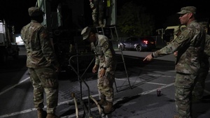 The 10th Mountain Division Sustainment Brigade help distribute water outside of the Watertown Municipal Arena to residents of Watertown, New York