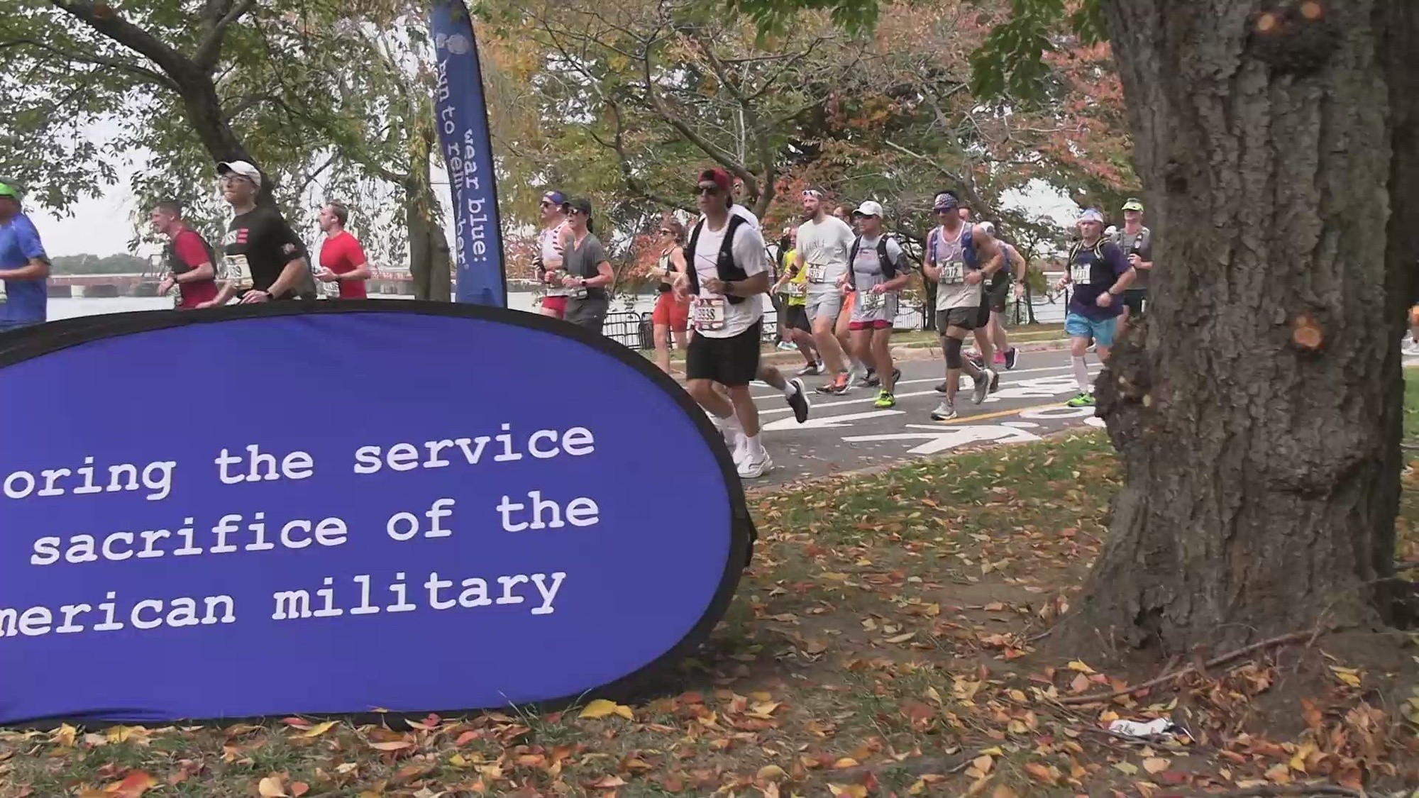 Runners participating in the 48th Marine Corps Marathon run through the &#39;wear blue: run to remember&#39; mile at Washington D.C., Oct. 29, 2023. The iconic course segment is a tribute intended to honor those who gave their lives for this country. The segment includes 225 posters with photographs of the Faces of the Fallen. (U.S. Marine Corps photo by Lance Cpl. Sean R. LeClaire)