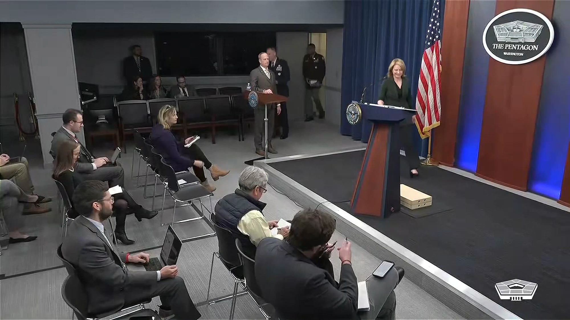 Deputy Defense Secretary Kathleen Hicks walks to the lectern in the Pentagon briefing room.