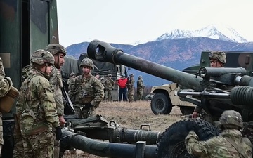 11th Airborne Division howitzer fire B-roll