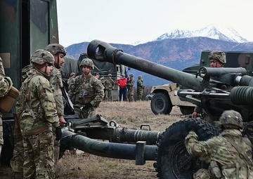 11th Airborne Division howitzer fire B-roll