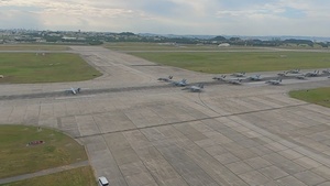 United in Strength: aircraft line the runway at Kadena Air Base B-roll (Aerial)