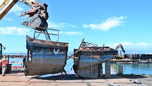 US Coast Guard oversees Western Maui Wildfires Emergency Support Function #10 operation to dismantle and transfer fire-damaged tugboat to disposition lot in Lahaina, Hawaii