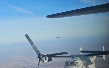 A U.S. Marine Corps MV-22B Osprey conducts tilt-rotor air-to-air refueling with a U.S. Air Force HC-130J Combat King II